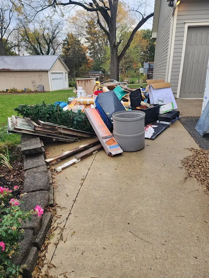 Dumpster being loaded with debris for Estate Cleanout Dumpster Rental in Beckley